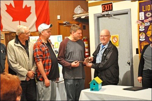 A Lions Foundation member hands over the Lions’ Den ceremonial key to a member of Canadian Mental Health Association North Battleford at a fundraising launch for CMHA North Battleford’s new building. Photos by Shannon Kovalsky