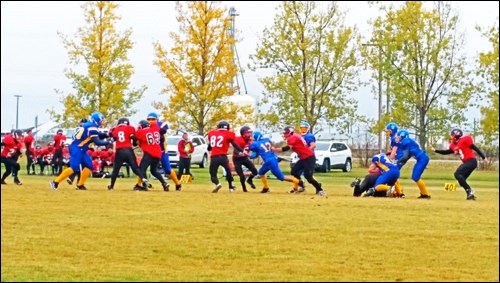 On a cool and damp Oct. 1, Unity Warriors rookies hosted the John Paul II Crusaders in a rookie game to keep building their skills in nine-man football played in their division and their league. Photos by Sherri Solomko