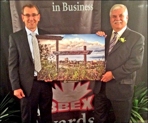 Battlefords Chamber of Commerce BBEX awards were presented at a ceremony at the Dekker Centre for the Performing arts Tuesday evening. The awards recognize excellence in the business community in the Battlefords and area. Biggar MLA Randy Weekes, representing Dustin Duncan the minister for SaskTel, presented the 2016 BBEX Business of the Year award to Kevin Driedger representing this year's winner, Fortress Windows & Doors. Photos by John Cairns