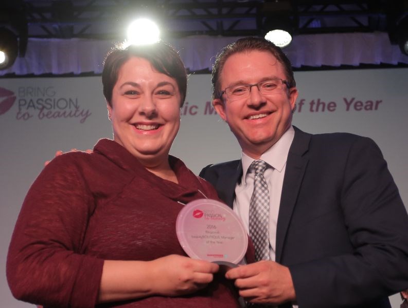 Former Kamsack resident Stefanie Brown received the award that named her as the top cosmetics manager in Saskatchewan and Manitoba from Gerald Scott, vice-president of operations for the two provinces.