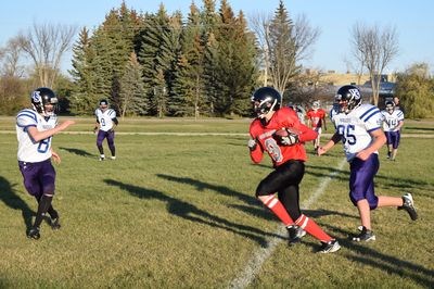 Jesse Biletsky ran with the ball during the home game for the Canora junior Cougars.