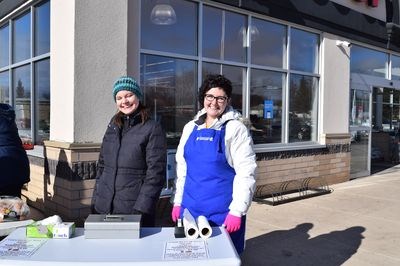 From left, Cheri Kuhn and Brittany Halkyard sold tickets at the barbecue.