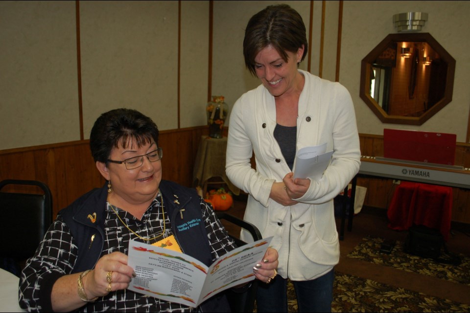 Marlene Shurygalo (seated) checks the agenda with guest speaker Deanna Brown, just prior to Brown’s presentation on volunteerism at the Saskatchewan Health-Care Auxiliaries Association convention.