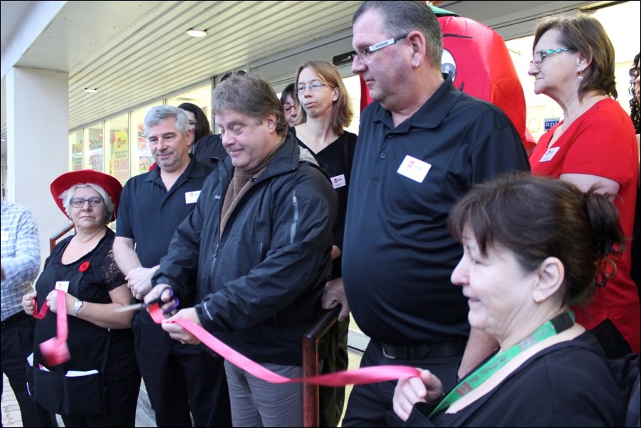 Flin Flon Mayor Cal Huntley, joined by dignitaries and employees, cut the ribbon to officially open the new Red Apple store on Main Street. The store, formerly The Bargain Shop, held its grand opening last Saturday, Oct. 29.