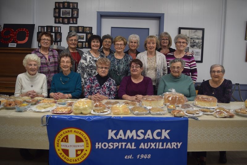 Members of the Kamsack Hospital auxiliary, which works to provide needed items at the hospital, from left, are: (standing) Jean Koreluk, Pauline Bear, Olga Rezansoff, Margie Popoff, Stella Sych, Marjorie Orr, Margaret Ratushny, Darlene Brown and Betty Salahub, and (seated) Betty Fedorak, Lena Matushek, Diana Belovanoff, Angie Cherwenuk, Olga Achtemichuk and Laurene Achtymichuk. “We sure could use more members, particularly young, strong bodies,” said a member of the auxiliary as the group posed for the photograph immediately prior to the beginning of the tea that was served on Friday afternoon.