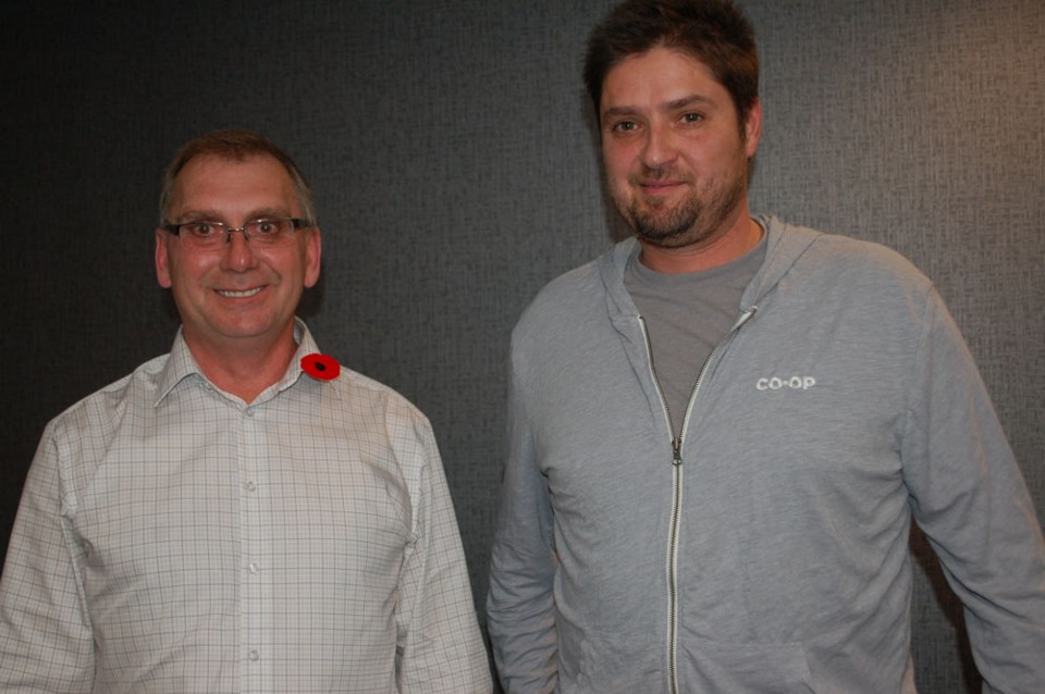 Southern Plains Co-operative manager Brian Enns (left) and Alameda Co-op manager Kendall Annetts dis