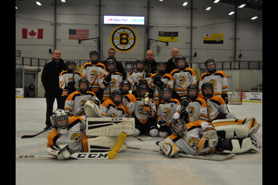 The Estevan Bruins Blue Sky Air atom AA Bruins celebrate their B-side championship at Affinity Place after beating the Regina Cougars 5-4 in their home tournament final.