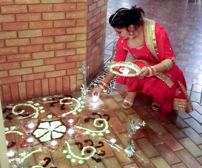 Spiritual light Lighting candles during Diwali (Festival of Lights) celebrations at St. Mary’s Cultural Centre November 3 signifies the victory of light over darkness, good over evil and welcomes Laksmi, the Hindu goddess of wealth. The designs on the floor are Rangoli, traditional patterns executed for decoration and to invoke good luck.