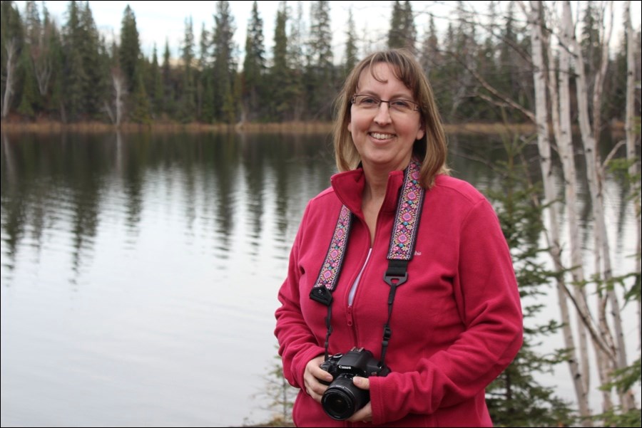 Local photographer Kathy Schwartz in front of Schist Lake.