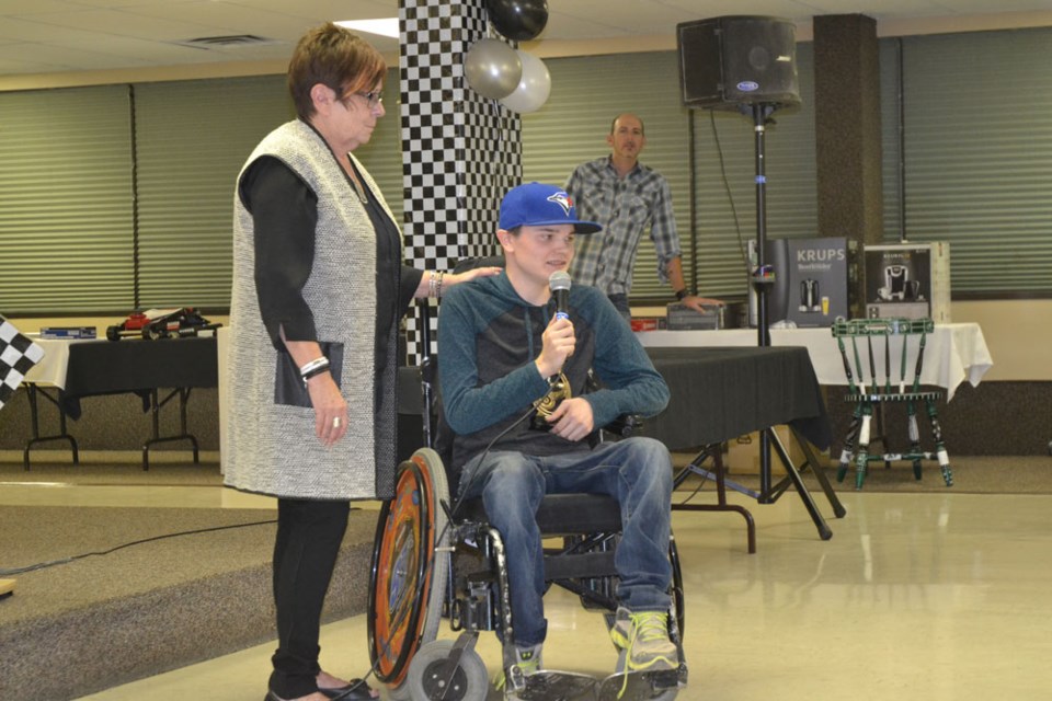 Riley Raynard, winner of the Clint Prette Memorial Award, expresses his surprise and gratitude at receiving the award, after having it presented to him by Estevan Motor Speedway treasurer Lynn Trobert.