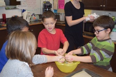 Forming balls of dough that would become oatmeal macaroons at the Canora Junior Elementary School cooking club meeting were, from left, Jayden Lepine, Xavier Brock (hidden), Merrick Derkatch and Liam Trask.