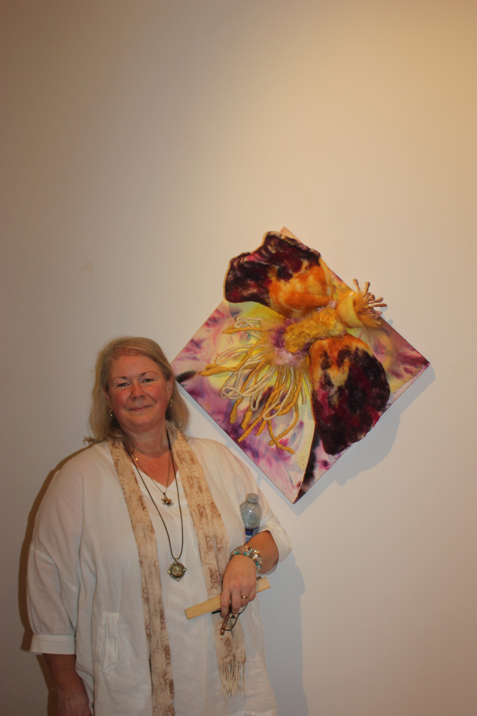 Sheila Farstad stands next to Big Purple/Yellow Hairy Flower, which was one of her submissions for t