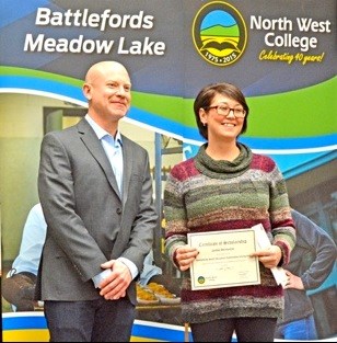 Jamie McHattie receives a scholarship for $500 from Carey Baker, a member of North West College's board of governors at a scholarship ceremony Friday, Nov. 27. Photos by Shannon Kovalsky