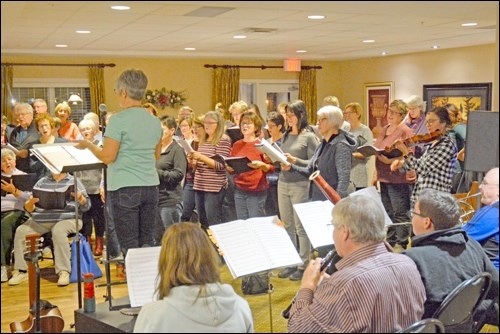 The choir practices songs for Candlelight Processional led by director Annette Duhaime before their debut at the Dekker Centre Nov. 27.