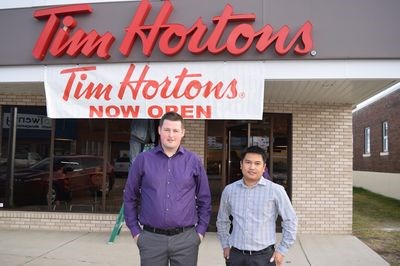 From left, Eric Ritchot (general manager) and Gerry Torres (provincial manager) were photographed in front of the new Tim Hortons location, which was open on November 17.