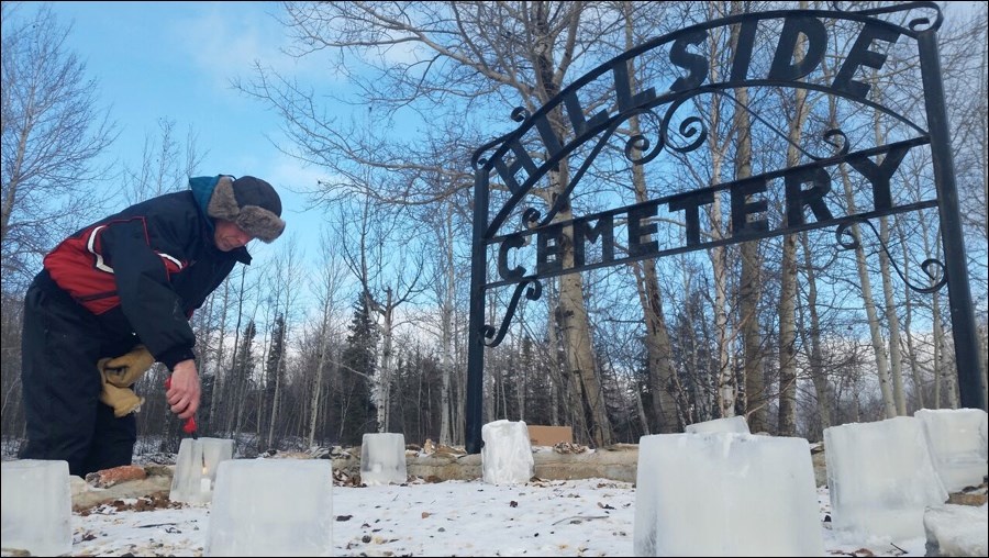 Brad Carpenter lights an ice-encased candle at Hillside Cemetery last Saturday, Nov. 19. The Anglican Parish of St. Peter and St. James sold “memory candles” to help local families remember departed loved ones, an annual fundraiser for the church.