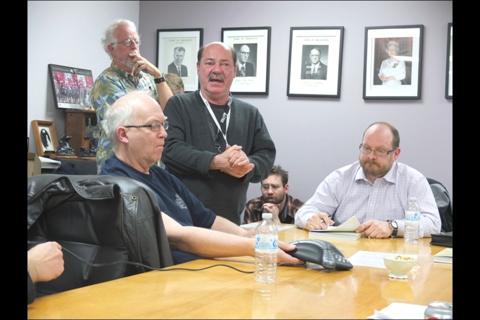 Nuclear Waste Management Organization spokesman Mike Krizanc addresses a public meeting at Creighton town hall in April 2014. Also pictured are Don Aasen (left), Buz Trevor (standing, back) and George Trevor.