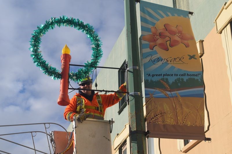 Although the sun was shining brightly at Kamsack on November 16, and there still was no snow on the ground, Darcy Green, high up in a cherry picker, fastened a holiday candle ornament on a light standard on main street. It is one of the many colourful decorations that town staff had placed in the business section of the community. They will help provide a Christmas appearance to the snowless landscape in advance of the community’s annual Christmas in November sale of crafts and home-based business products that was held on the weekend, and will prepare everyone for the visit of Santa Claus who will be the featured guest tomorrow (Friday) at the annual Moonlight Madness parade.