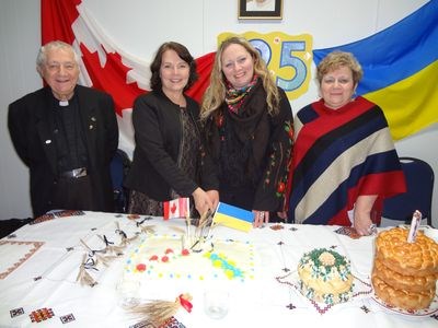 Cutting the cake to commemorate the 125th anniversary of Holodomor, from left, were Rev. Methodius Kushko, Cathay Wagantall, Oksana Burback and Catherine Zanevich.