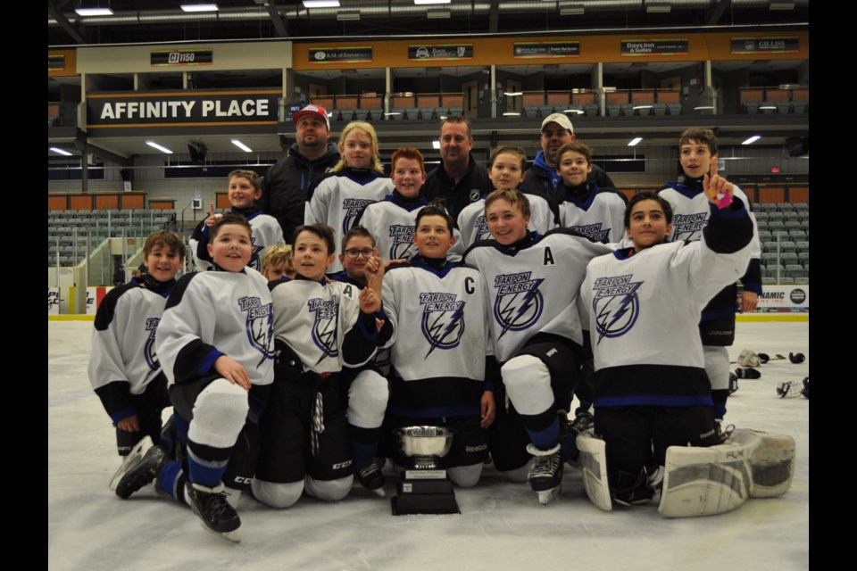 The Estevan Storm celebrate their home tournament championship after defeating the Swift Current Rustlers 5-4 in a shootout.