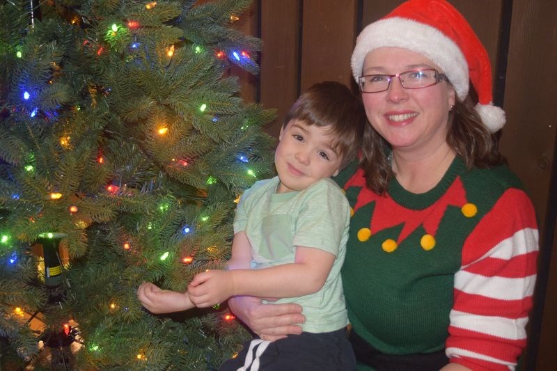 Jameson Parnetta found a lighted Christmas tree to play under, while his mother, AnnaLee, also known as “the costume lady” was dressed as an elf while tending a booth at the Christmas in November event in Kamsack on November 20.
