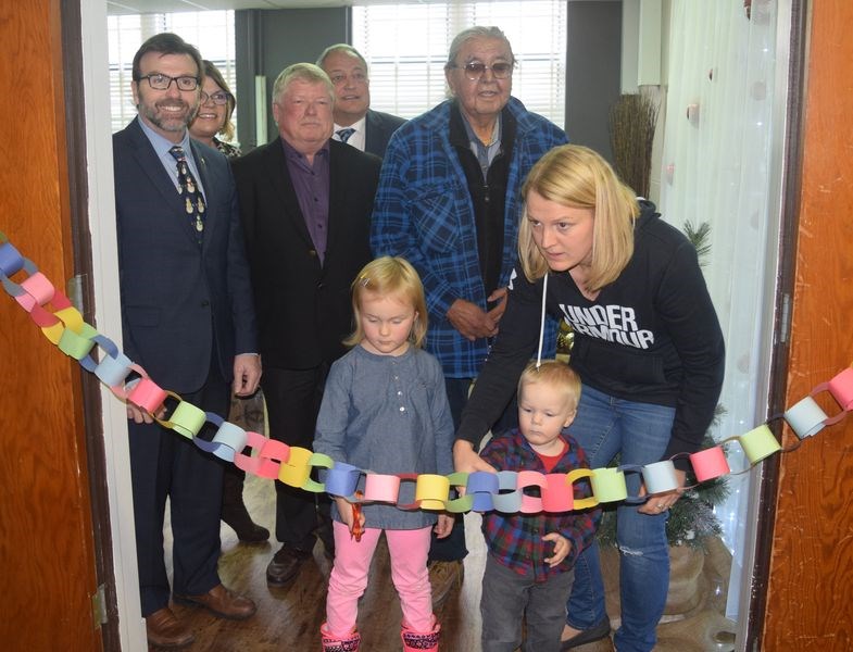 Using a “ribbon” created from paper links, Kacee and Emmett Kitchen, with their mother Chantel, had the privilege of cutting the links to mark the official opening of the Kamsack Family Resource Centre on Friday. Also in the photo, from left, were: Greg Ottenbreit, minister for rural and Remote Health; Suann Laurent, president and CEO of Sunrise Health Region; Don Rae, Sunrise board chair; Terry Dennis, Canora-Pelly MLA, and Frances Bird, a First Nation elder.
