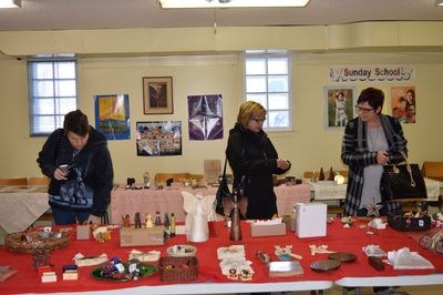 Women examined the various products that were being sold at the Ten Thousand Villages sale.