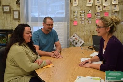 In the photo, Katherine Rewakowski, left, and her husband Darcy met with Jennifer Prychak.