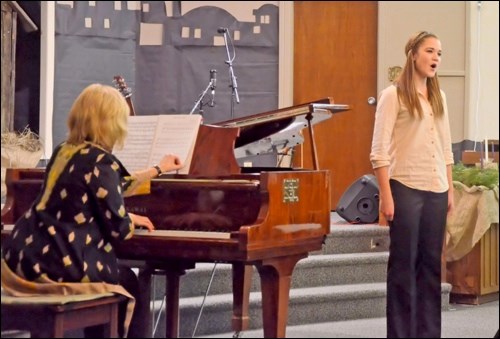 Dianne Gryba plays the accompaniment for music student Jordyn Nachtegaele as she sings a German song about nature and love.