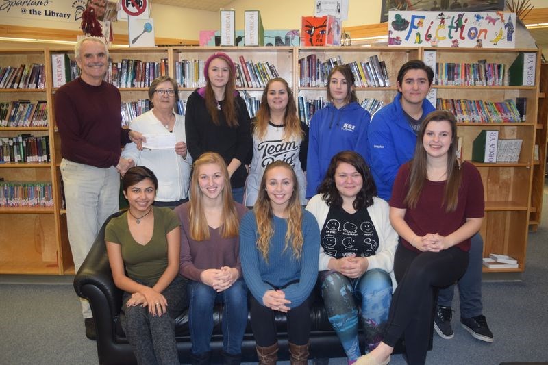 Last week Bryan Cottenie, standing at left, who is a district delegate for Affinity Credit Union, presented a cheque from the Community Development Fund of $1,000 to the Kamsack Comprehensive Institute senior drama club, which will be staging a one-act drama called Moving at the KCI and at the regional drama festival in the spring. With Cottenie, from left, were: (standing) Barb Tetoff (who received the cheque on behalf of Krystal Deveau, the teacher director), Shaelyn Matwijeczko, Serina Wyllychuk, Alexis Koroluk and Brayden Fatteicher, and (seated) Elisabeth Ashley, Allison Thomsen, Breanna Bland, Elizabeth Hilderman and Allison Placatka. Deveau and Alanna Finnie were the two members of the club who were not available for the photo.