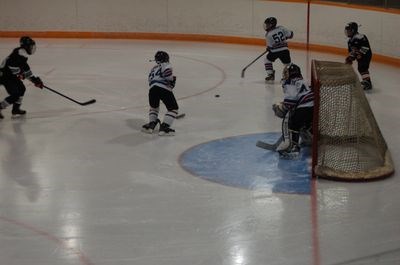 Mason Babiuk, left, and Cole Masley helped goaltender Riley Kuta protect the net.