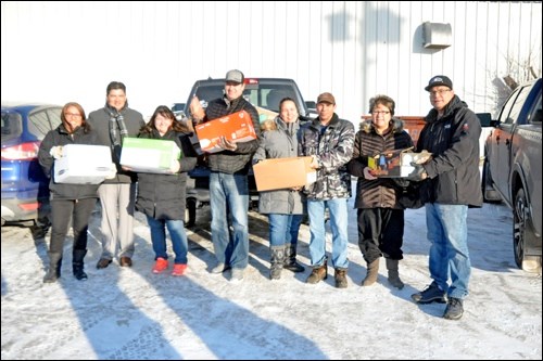 A number of high-ranking Chiefs from local First Nations as well as FSIN Chief Bobby Cameron were on hand to make a major donation to the Battlefords Indian and Métis Friendship Centre’s Housing First program. The food was loaded into a freezer and will be distributed to Housing First clients on Fridays. Shown left to right: Sweetgrass Chief Lori-Ann Whitecalf, FSIN Chief Bob Cameron, Nikki Standinghorn, Saulteaux Chief Kenny Moccasin, Jackie Kennedy, Dan Villeneuve, Lucky Man Councillor Joanie Buffalo and Lucky Man Chief Terry Okemow.  Photos by John Cairns