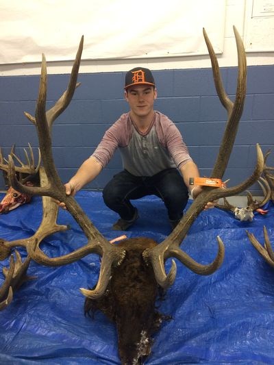 Bo Babiuk was photographed with a set of large elk antlers brought in by Justin Keller.