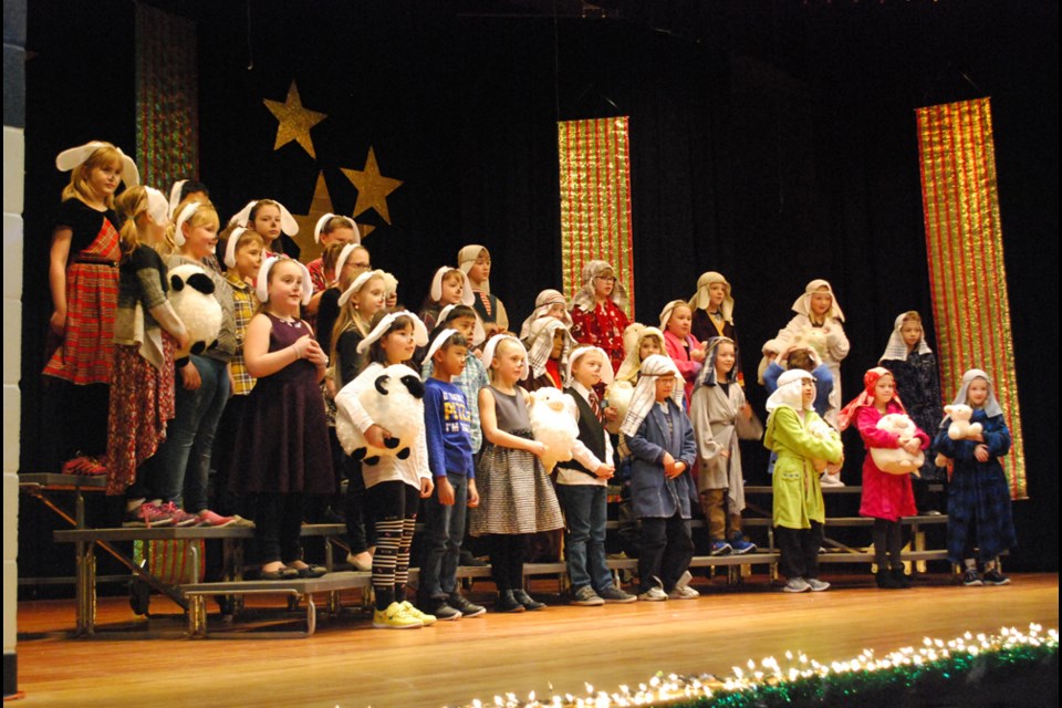 Both shepherds and sheep lament about all the work they have to do in the grade 3 song, “What does it take?” at the St. Augustine Christmas Concert on Dec. 15. Both afternoon and evening shows saw a packed St. Augustine gym. photo by Becky Zimmer