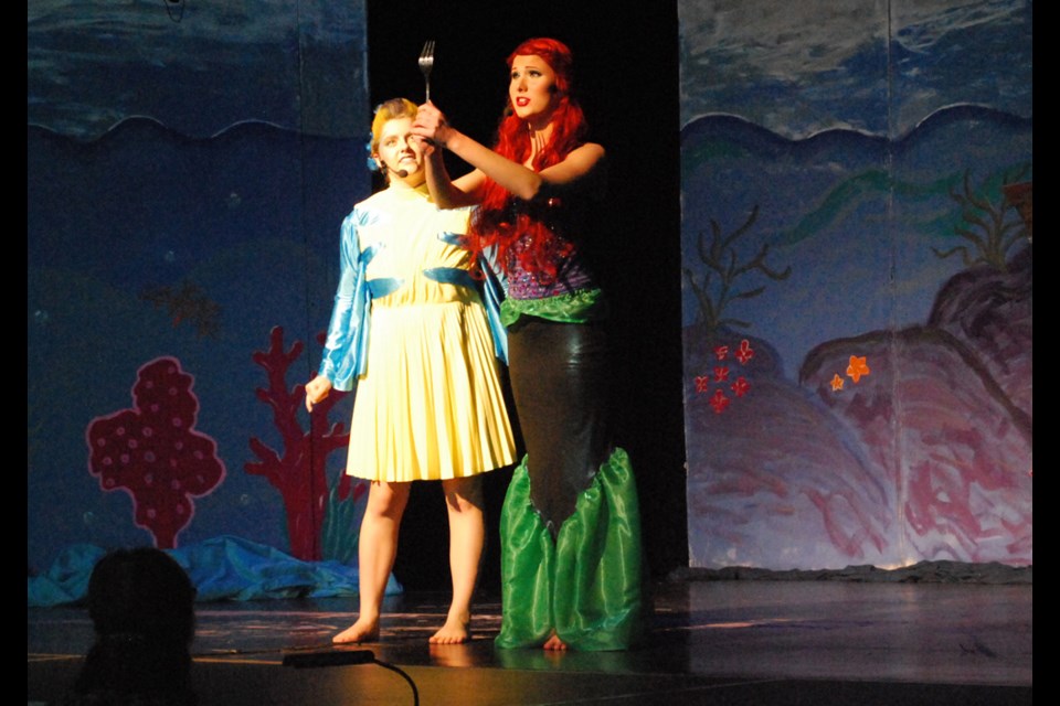 Ariel (Faith Schuler) and Flounder (Samantha Seidle) wonder what magical human object they found under the sea during HCI's performance of Little Mermaid Jr.