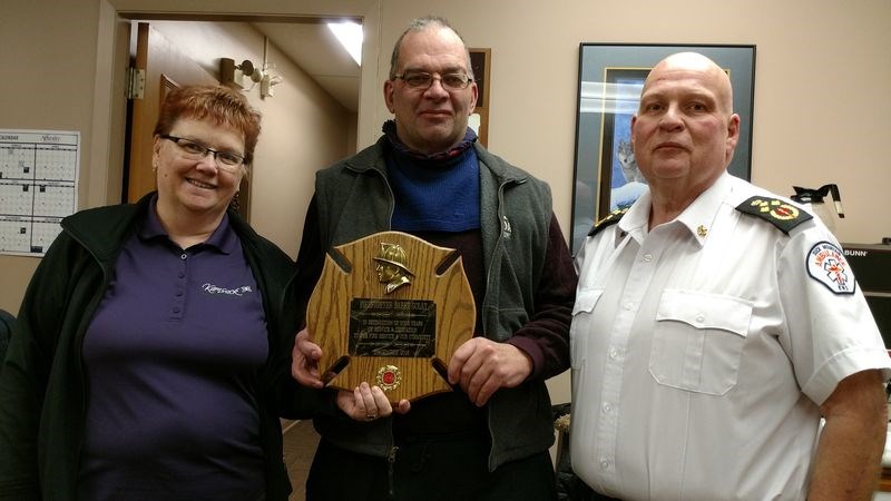 At the town council meeting of December 12, (top photo) Mayor Nancy Brunt and Jim Pollock, fire chief (right), presented a plaque to Barry Golay in recognition of his more than 20 years of service to the Kamsack Volunteer Fire Department.