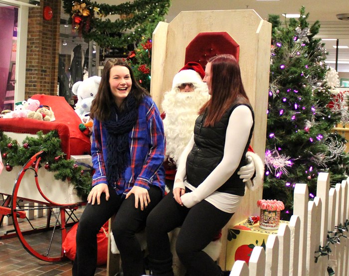 Santa Claus listens to people’s Christmas wishes at the Parkland Mall on December 17.