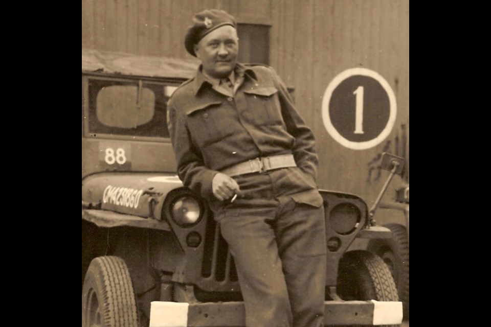 Ben Grimmelt in front of his jeep during service overseas (location unknown).
