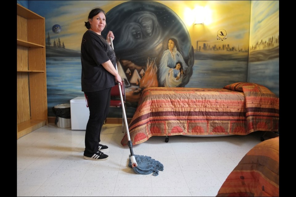 Housekeeper Margaret Chisholm mops the floor in a suite at the hostel at the Flin Flon Aboriginal Friendship Centre.