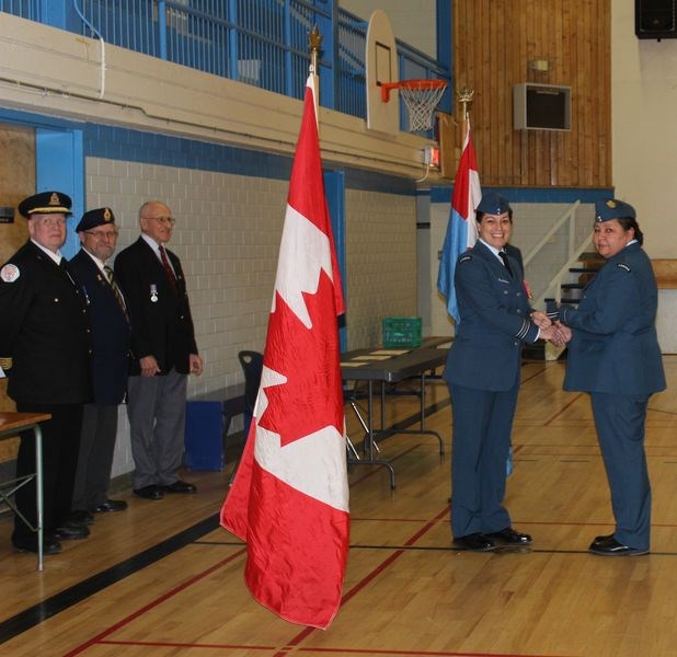 Karen Tourangeau, right, was promoted to second lieutenant by Tami Marchinko, the presiding officer during the change of command ceremony in Kamsack last month. At left are Jim Pollock, Jim Woodward and Milton Glaicar.