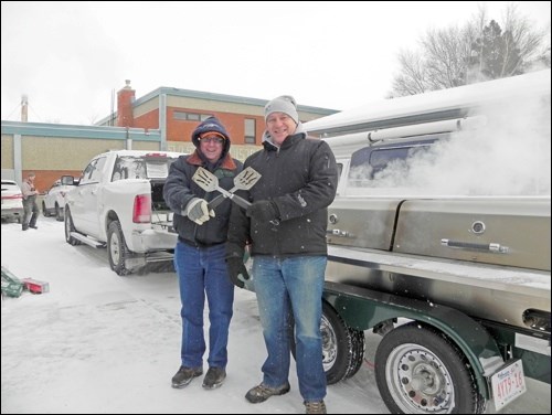 Darren Stifter and Ted Stabbler didn’t let a little cold weather stop their efforts as they cooked up a storm for the kick off to the “Unite for a Miracle” Telemiracle fundraising campaign. Photos by Sherri Solomko