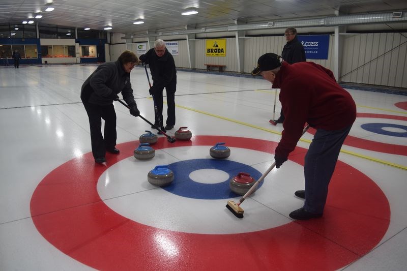 On Monday and Thursday afternoons at the Broda Sportsplex in Kamsack about 25 curlers, all on the highly-respected side of 55 years of age, meet to curl with fellow members of Club 55. Among the curlers on the ice on Thursday last week helping a rock find its resting place, from left, were: Shirley Peesker, Gerry Isabey, Bill Helmkay and Stuart Severight.
