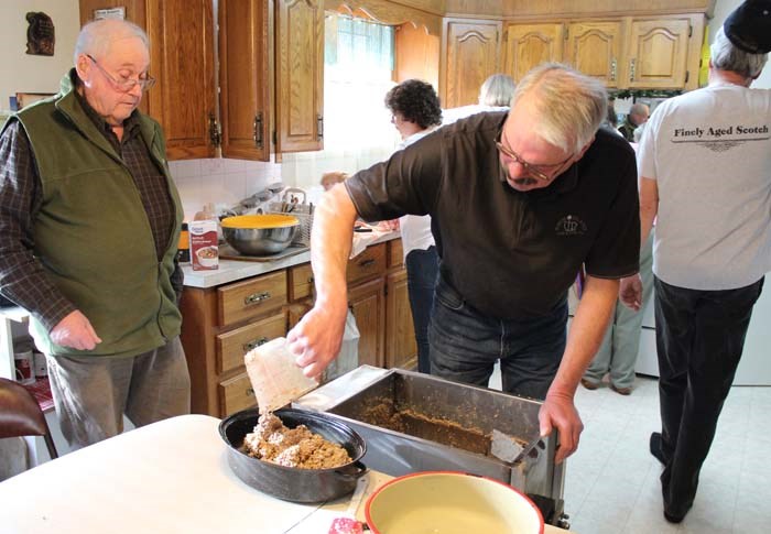 The haggis mixture goes into the roasting pans.