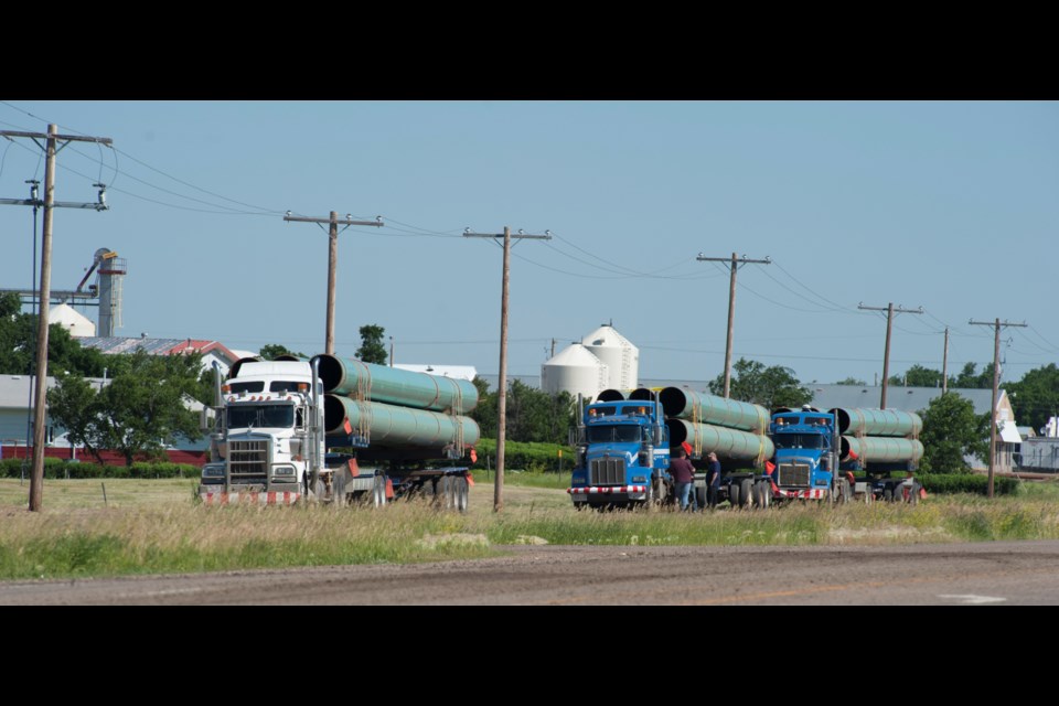 These trucks were photographed in 2011, hauling pipe through Shaunavon for the Keystone XL pipeline. That pipe sat in a field for the better part of a decade, until it was taken back to Regina to be inspected and recoated as needed over 2018-2019.