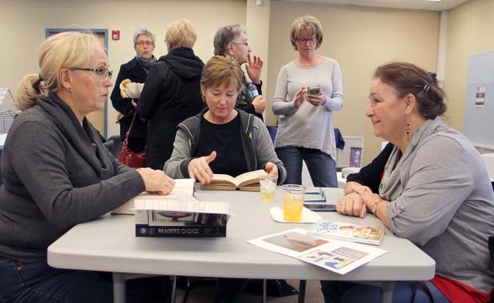 Getting ready to make some art, attendees at the Upcycle Books event at the Yorkton Public Library search for inspiration from the repurposed reading materials.