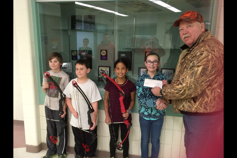 CCS students who accepted a donation from Hal Thomas, right, of the River Ridge Fish and Game, from left, were: Hunter Secundiak, Colin Katryniuk, Methyl Trask and Jaden Burym.