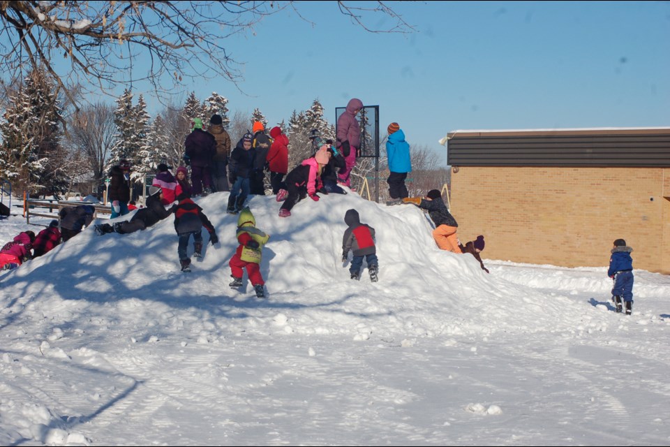 Many children enjoyed scrambling on the snow hill at the Preeceville School yard on January 27.