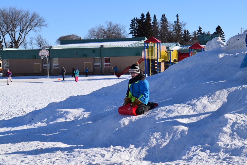 Cody Vangen enjoyed sliding down the hill of snow in the yard of Canora Junior Elementary School.