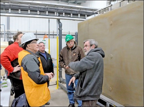 Chief operating officer of Soneera Water LLC Geoff Hukins, right, describes the size and shape of the panels inside the MemFree water treatment unit behind him. Listening are Unity mayor Ben Weber and councillors Brent Weber, Robert Abel and Brian Vanderlinde. Town council and staff toured Unity’s new wastewater treatment plant Feb. 5. Photo by Helena Long