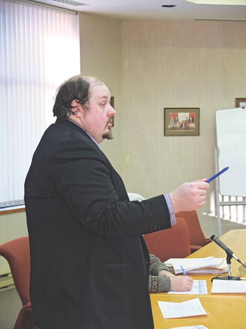 Auctioneer Raphael Saray scans the crowd for bids during the City of Flin Flon tax auction sale.